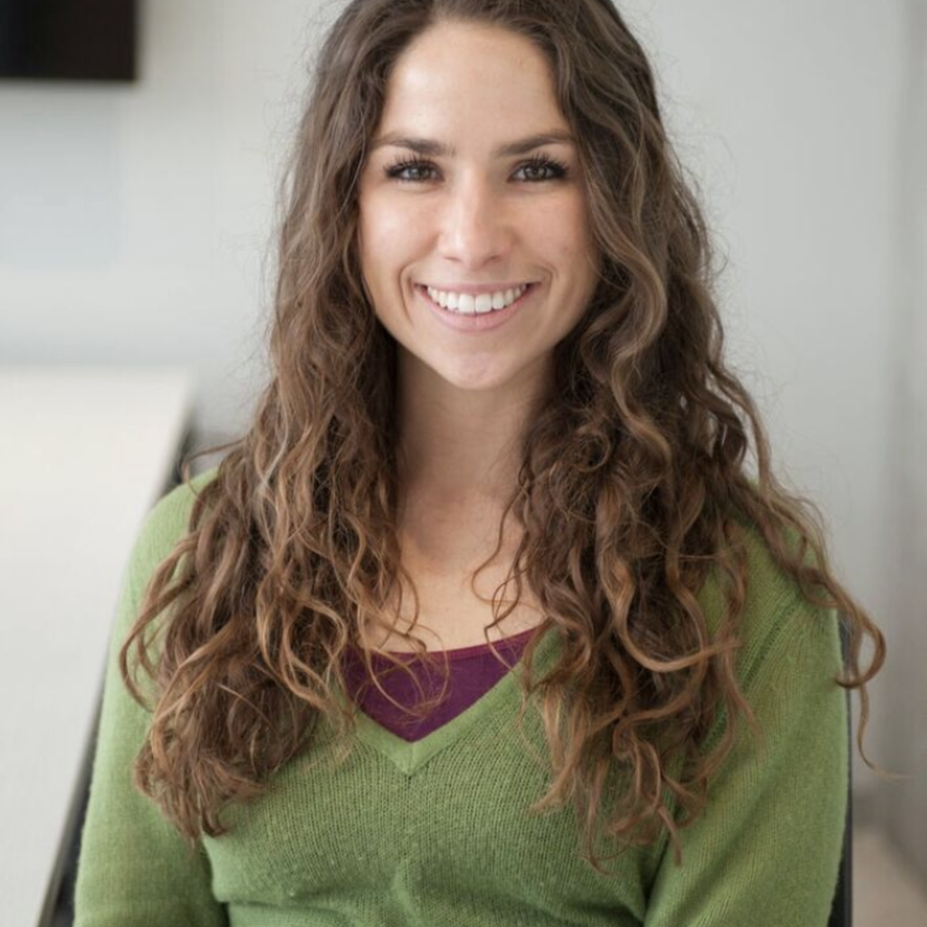 A young woman smiles at the camera