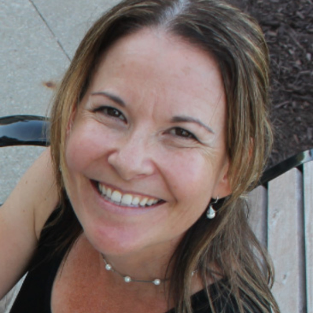 A young woman smiles at the camera