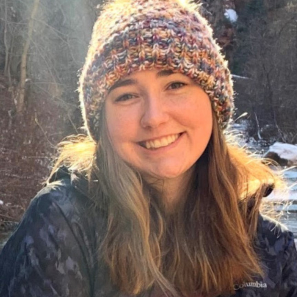 A young woman smiles at the camera