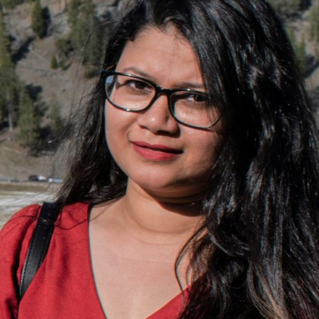 A young woman smiles at the camera