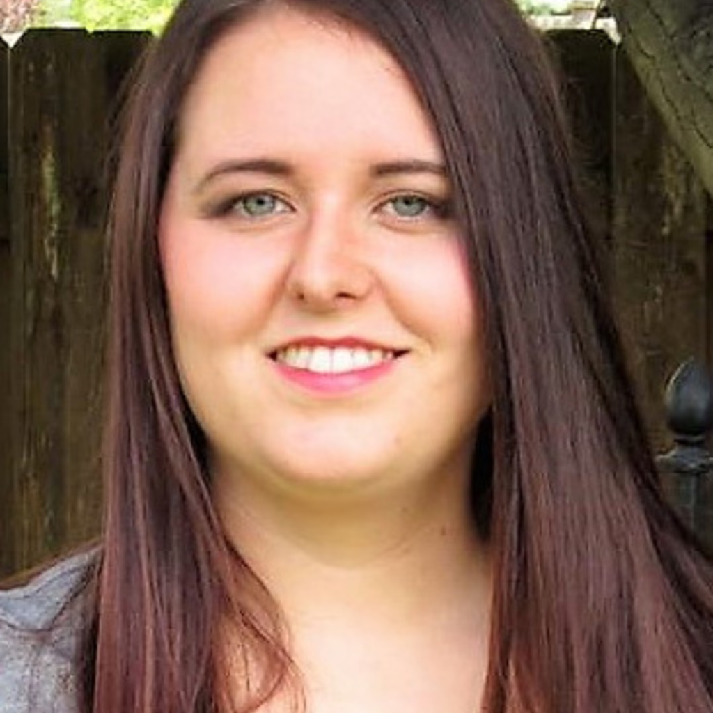 A young woman smiles at the camera