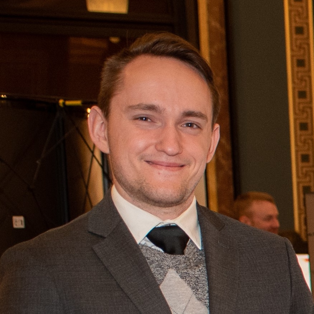 Professional headshot of a young man